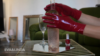 EvaAndLinda - Linda strokes a bottle in latex gloves